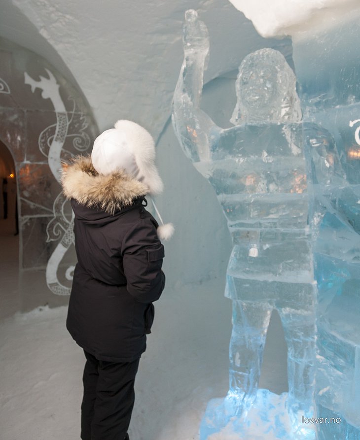 Girl looking at an ice sculpture of a man