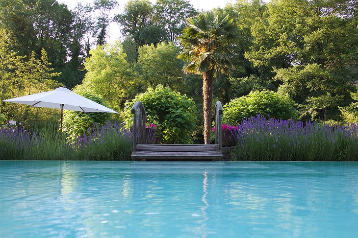 Hotel Le Moulin du Roc pool and the green garden