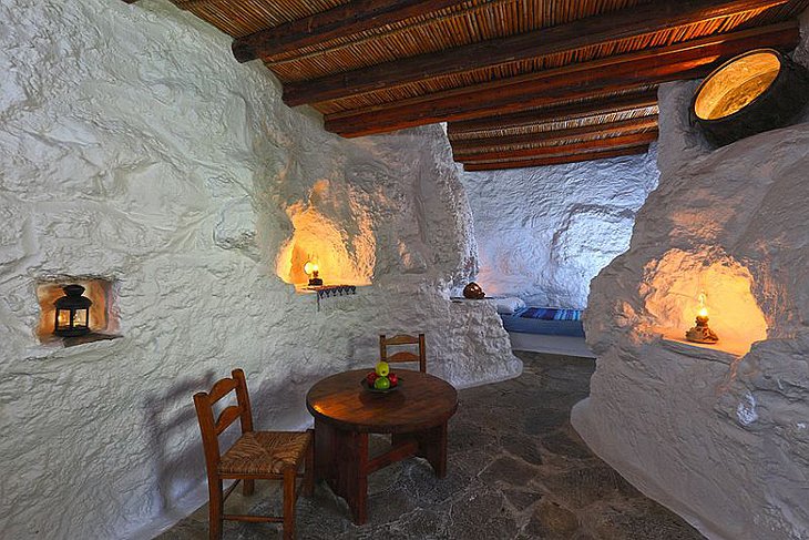 Aspros Potamos Hotel room with white walls and wooden furniture