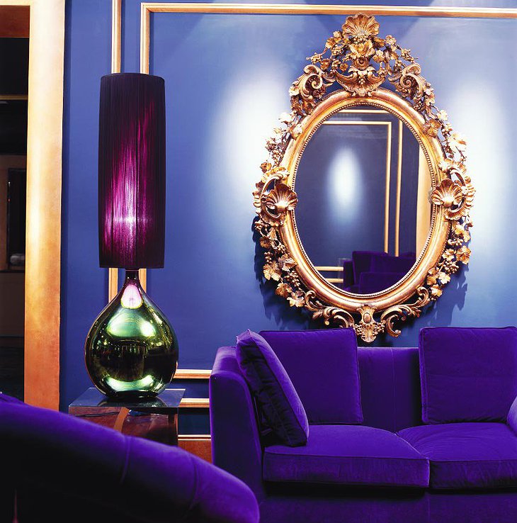 Purple sofa and golden mirror