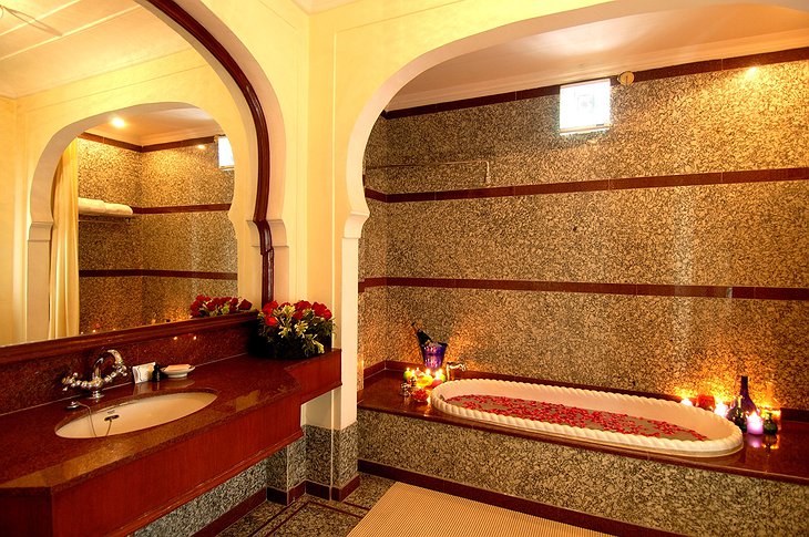 The Raj Palace bathroom with tub full of flowers