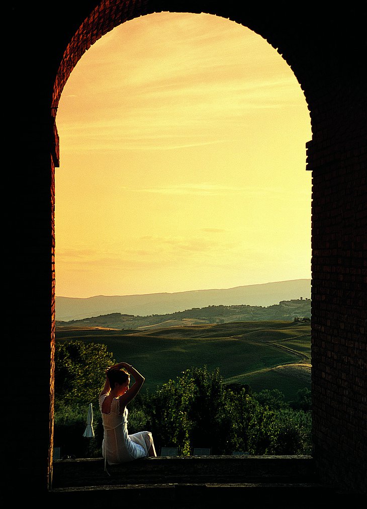 Girl sitting in the window to Tuscany