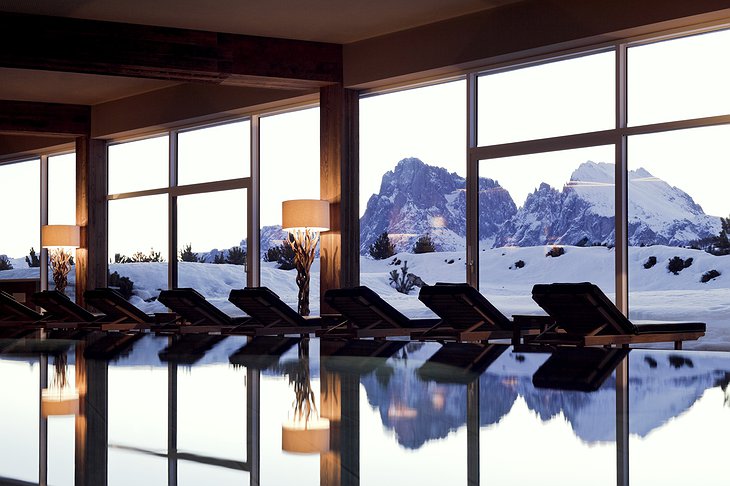 Alpina Dolomites hotel indoor swimming pool with snowy mountain view