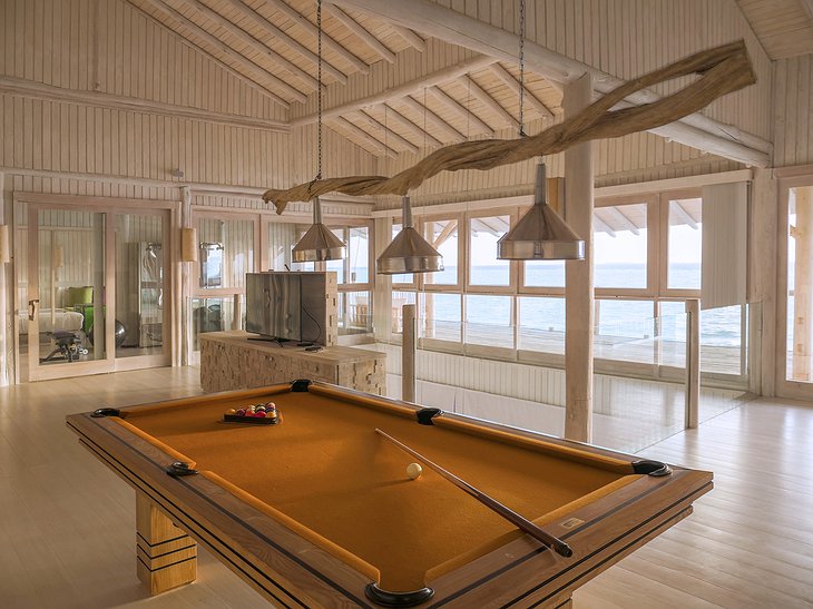Soneva Jani Maldives 4 bedroom water villa interior with billiard