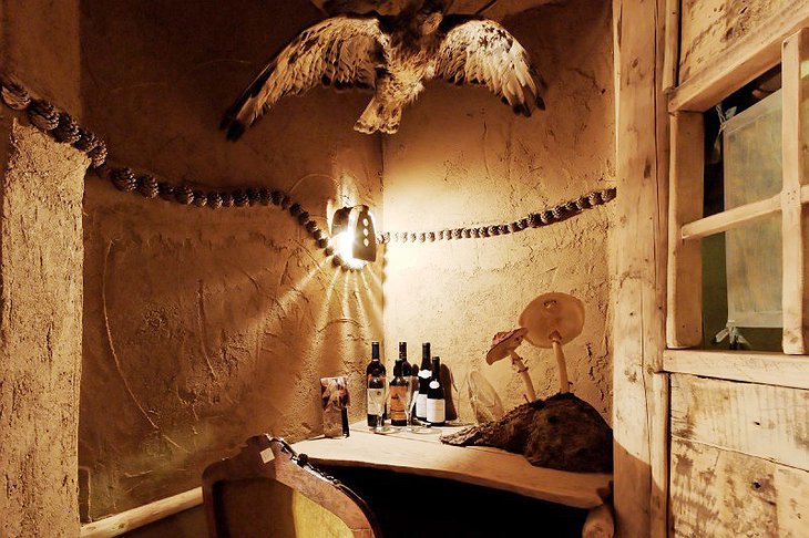 La Balade des Gnomes wine corner with giant mushrooms and dead animals