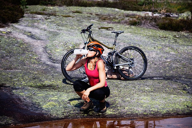 Biker girl drinking fresh water