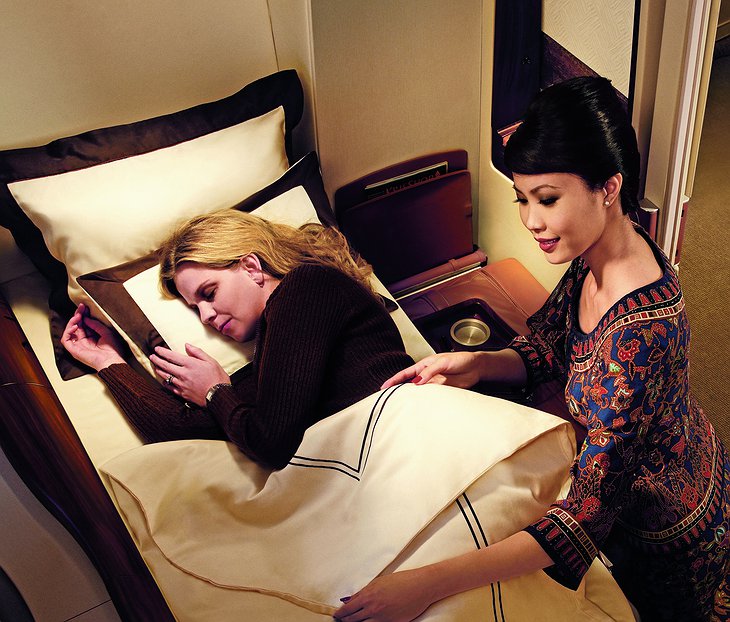 Singapore Airlines stewardess and the passenger in the suite