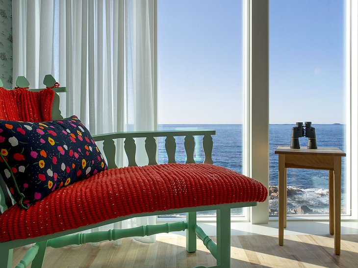 Fogo Island Inn room with green chair and panoramic sea views
