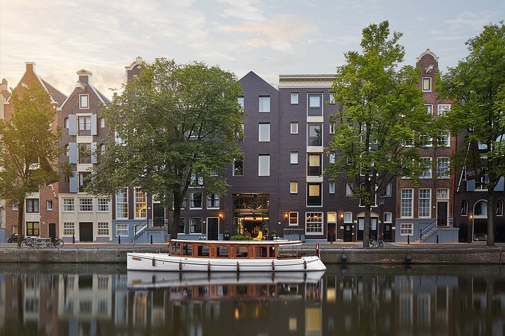 Pulitzer Amsterdam exterior with canal and a boat