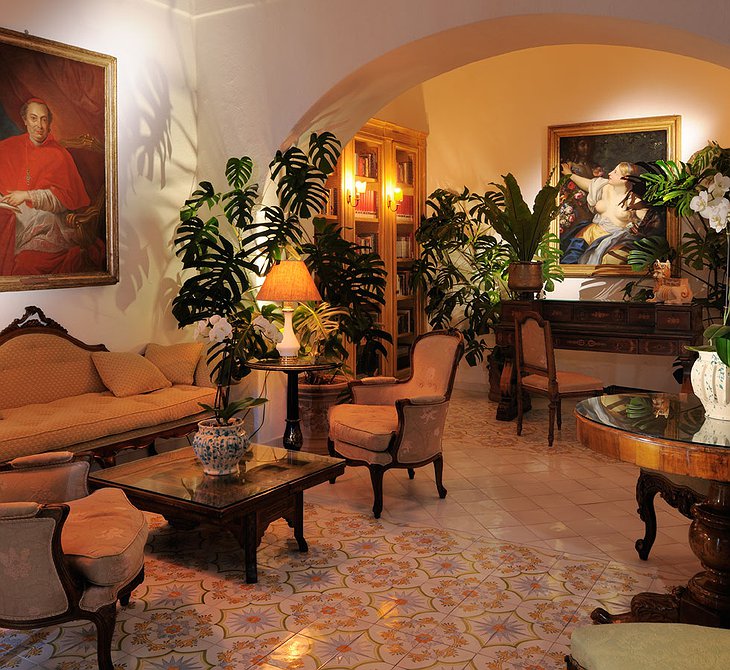 Le Sirenuse Hotel interior with vintage paintings on the wall