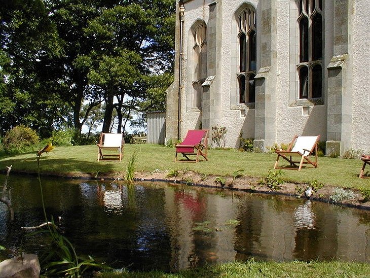The Old Church of Urquhart garden with a pond