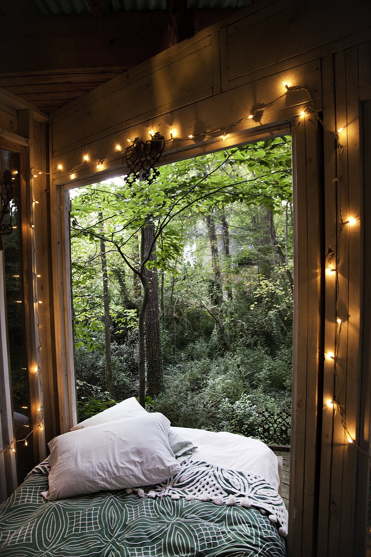 Secluded Intown Treehouse bedroom with open windows to nature