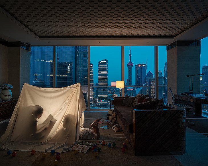 Regent Shanghai Pudong room at night with kids playing