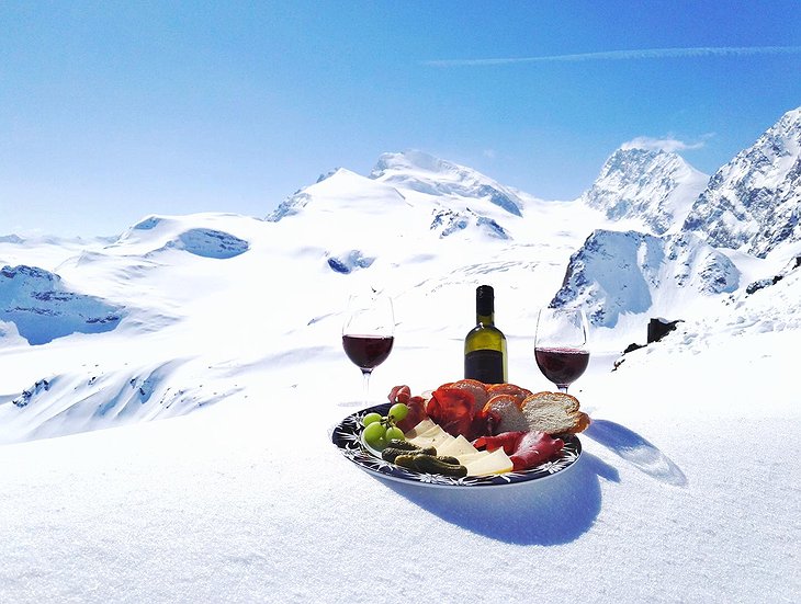 Wine Swiss appetizers in the snowy Alps
