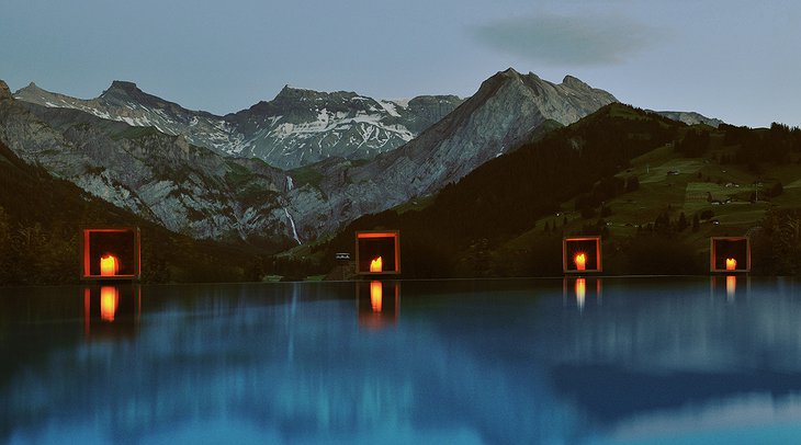 The Cambrian outdoor swimming pool at night with lights and view on the mountains