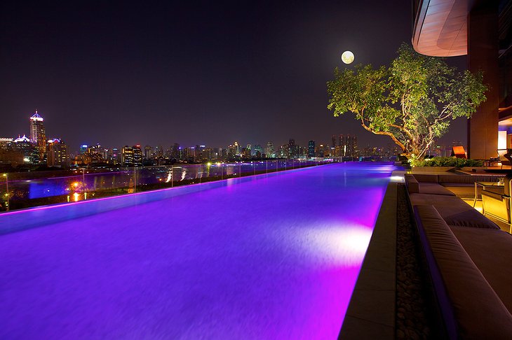 Infinity Pool at night with purple lights
