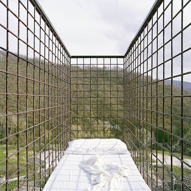 Suspended cage bed with panoramic views on forest and the stars above