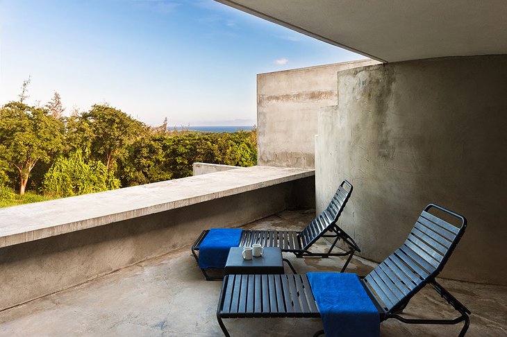 Triangular house concrete terrace with sea view