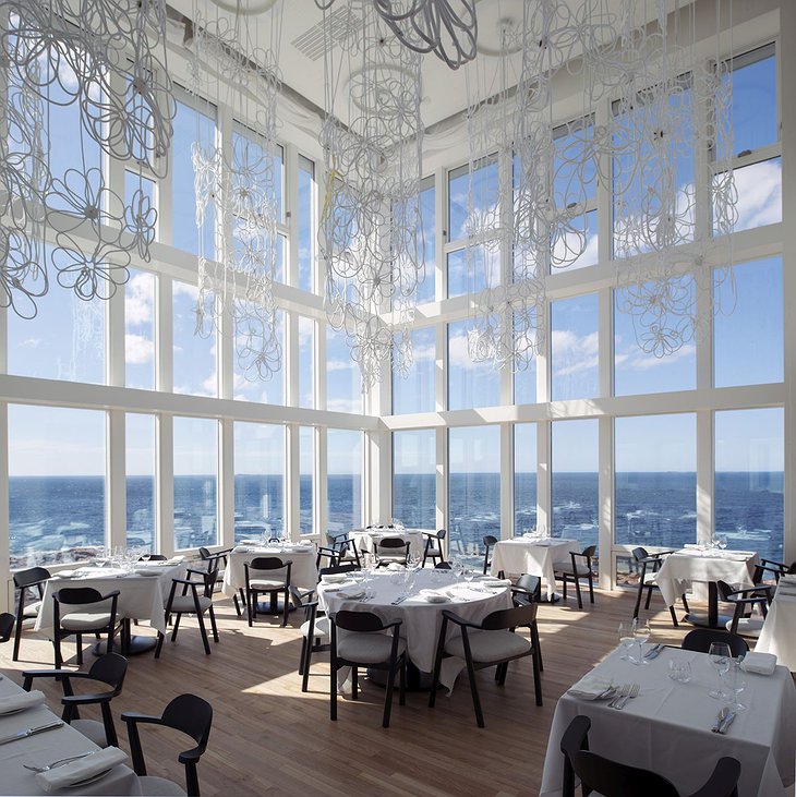 Fogo Island Inn restaurant with floor to ceiling windows overlooking the Northern Atlantic sea