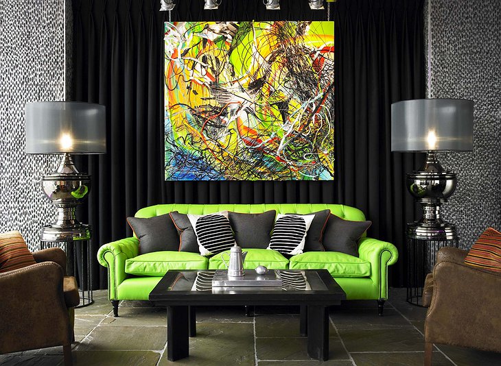 Salthouse Harbour Hotel lounge with green sofa and modern art painting on the wall