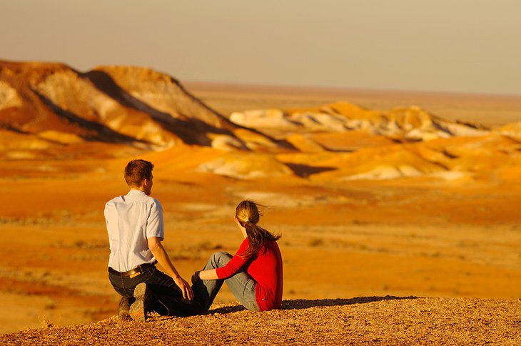 Couple sitting in the desert next to Coober Pedy in Australia