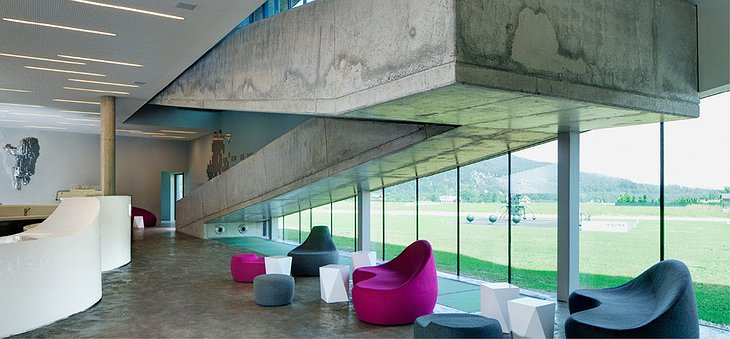 Miura Hotel interior with concrete staircase and colorful furniture