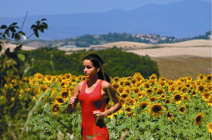 Girl running in the Tuscan nature