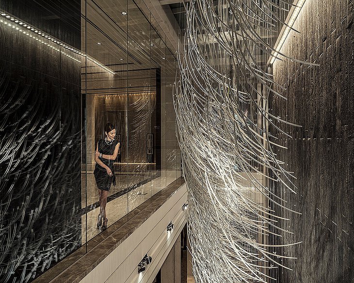 Regent Shanghai Pudong interior design details examined by a classy lady in black dress
