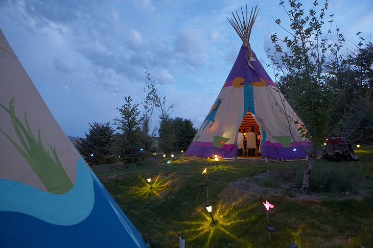 Mustang Monument Resort tipis at night with small lights on the ground