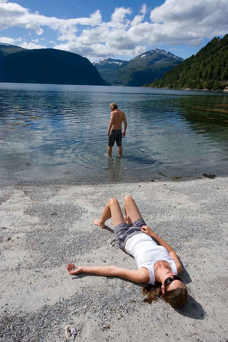 Girl lying on the beach of a lake