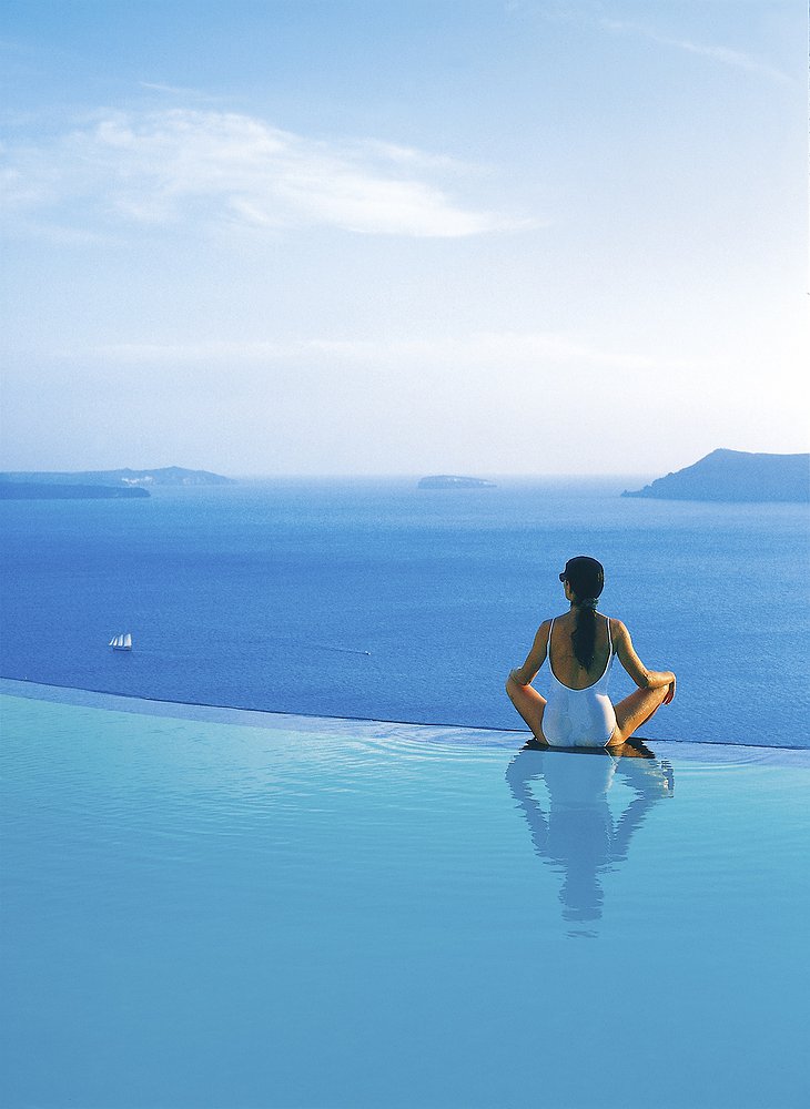 Girl sitting at the edge of the infinity pool