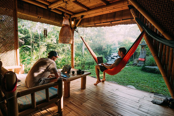 Guys chilling in the hammock at the Hideout Bali bamboo house