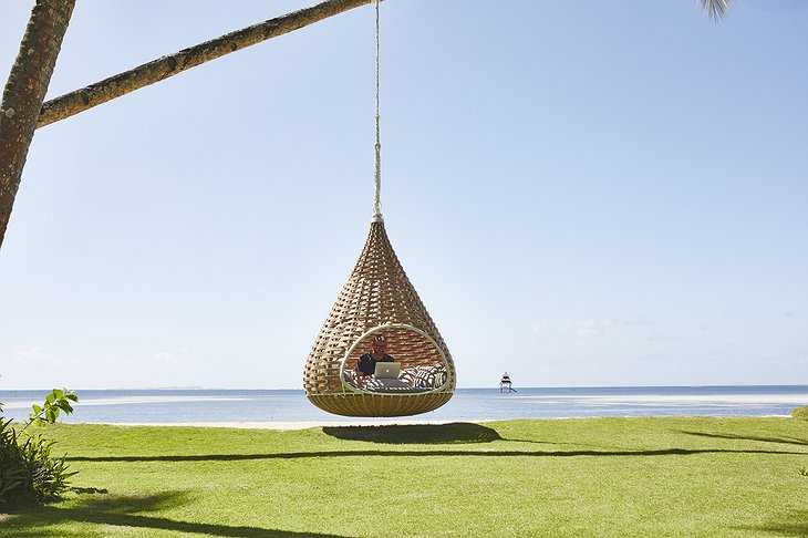 Swinging chair from palm tree on the beach