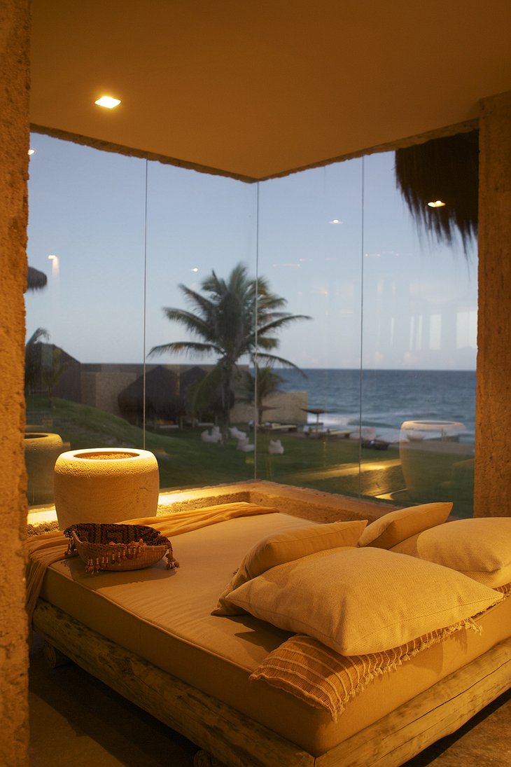 bedroom with bottom to ceiling glass with sea view