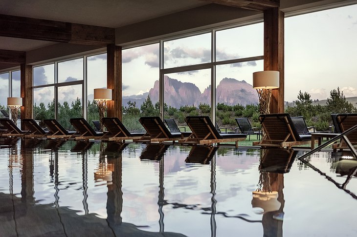 Alpina Dolomites hotel indoor swimming pool with summer mountain view