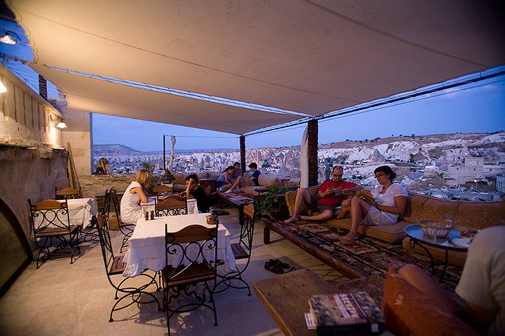 Kelebek Cave Hotel rooftop terrace with people enjoying in the evening
