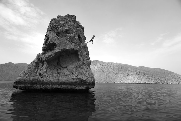 Jumping from the rocks in Zighy Bay