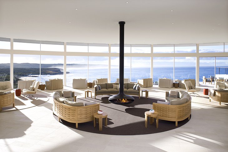 Southern Ocean Lodge common room with fireplace and breathtaking view on the sea