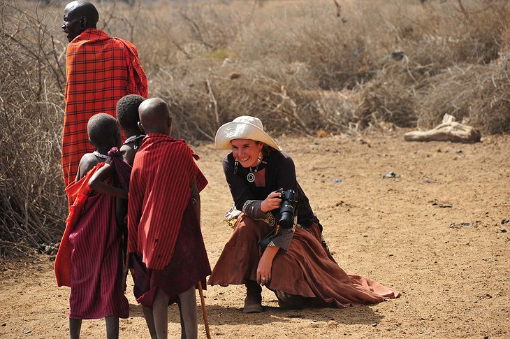 Woman interacting with kids from a Tanzanian tribe