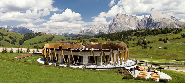 Alpina Dolomites hotel with garden and mountains around