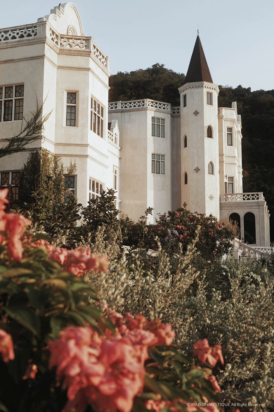 Maison Mystique Side View with Flowers