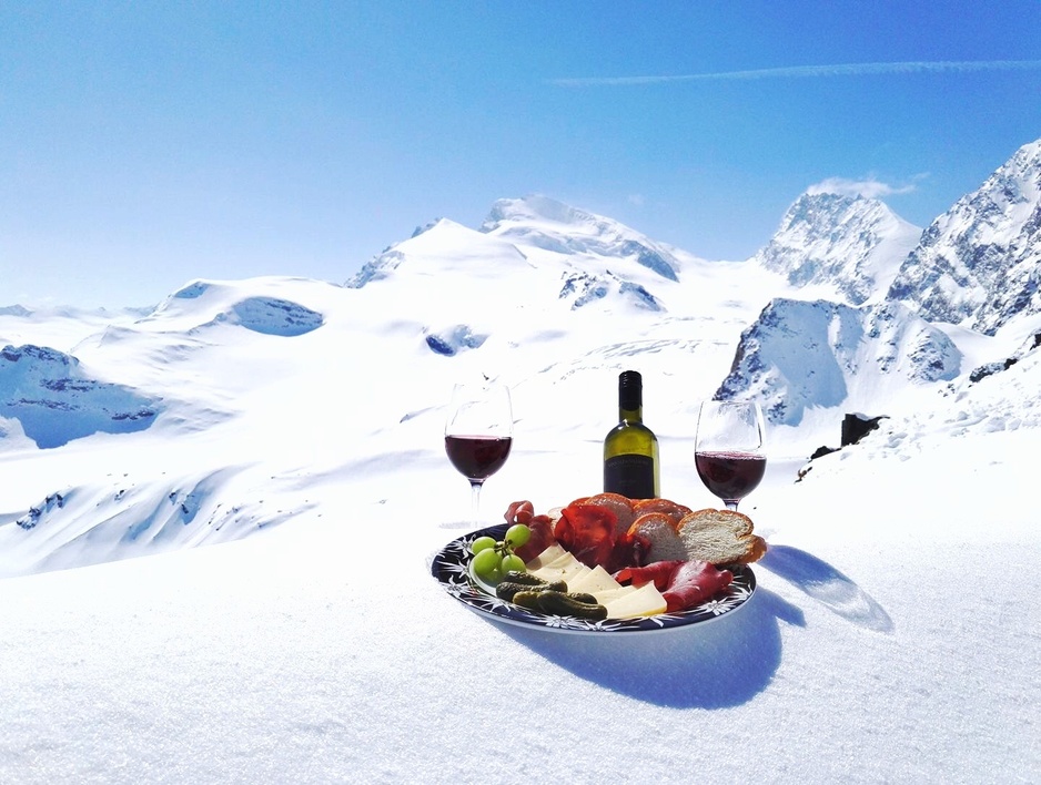 Wine Swiss appetizers in the snowy Alps
