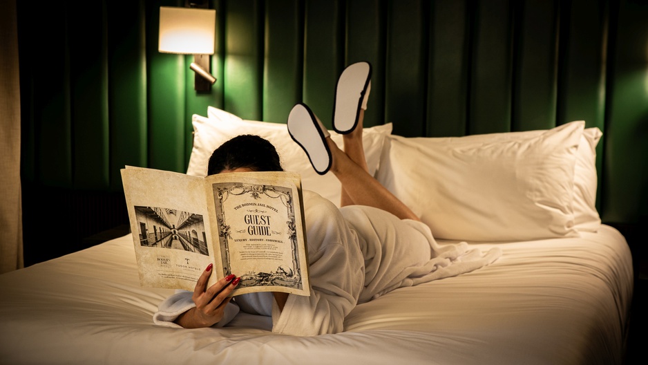 The Bodmin Jail Hotel Girl on the Bed Reading the Hotel's Newspaper