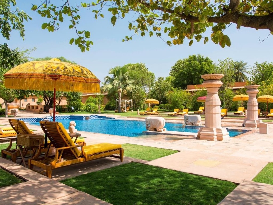 The Oberoi Vanyavilas swimming pool with umbrellas