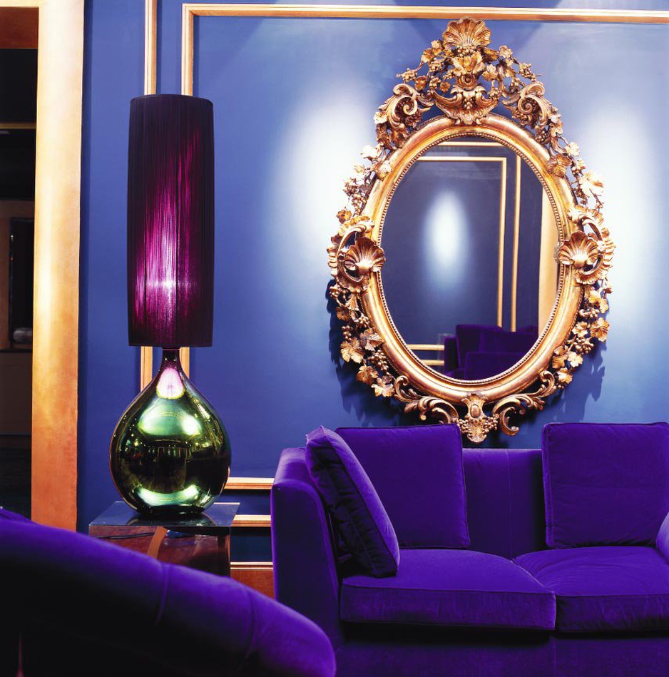 Purple sofa and golden mirror