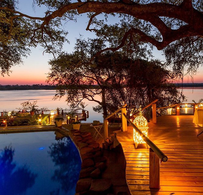 Tongabezi lodge pool at night by the Zambezi River