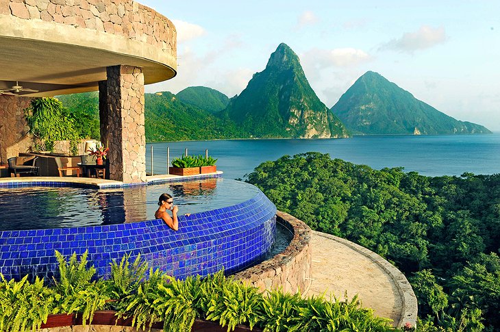 Infinity pool with woman drinking coctail