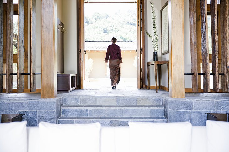 COMO Uma Punakha woman walking out from the living room