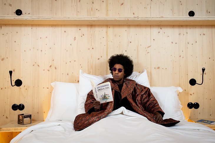 Zero Box Lodge Guy Reading in the Bed