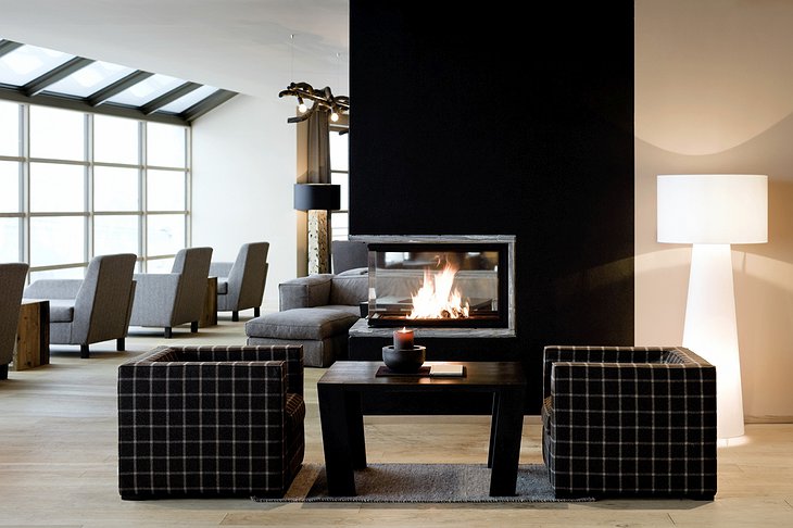 Alpina Dolomites hotel lounge with fireplace